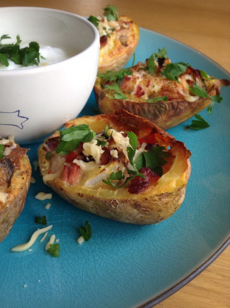 Healthy spicy breakfast potato skins with eggs, bacon, onions and mushrooms