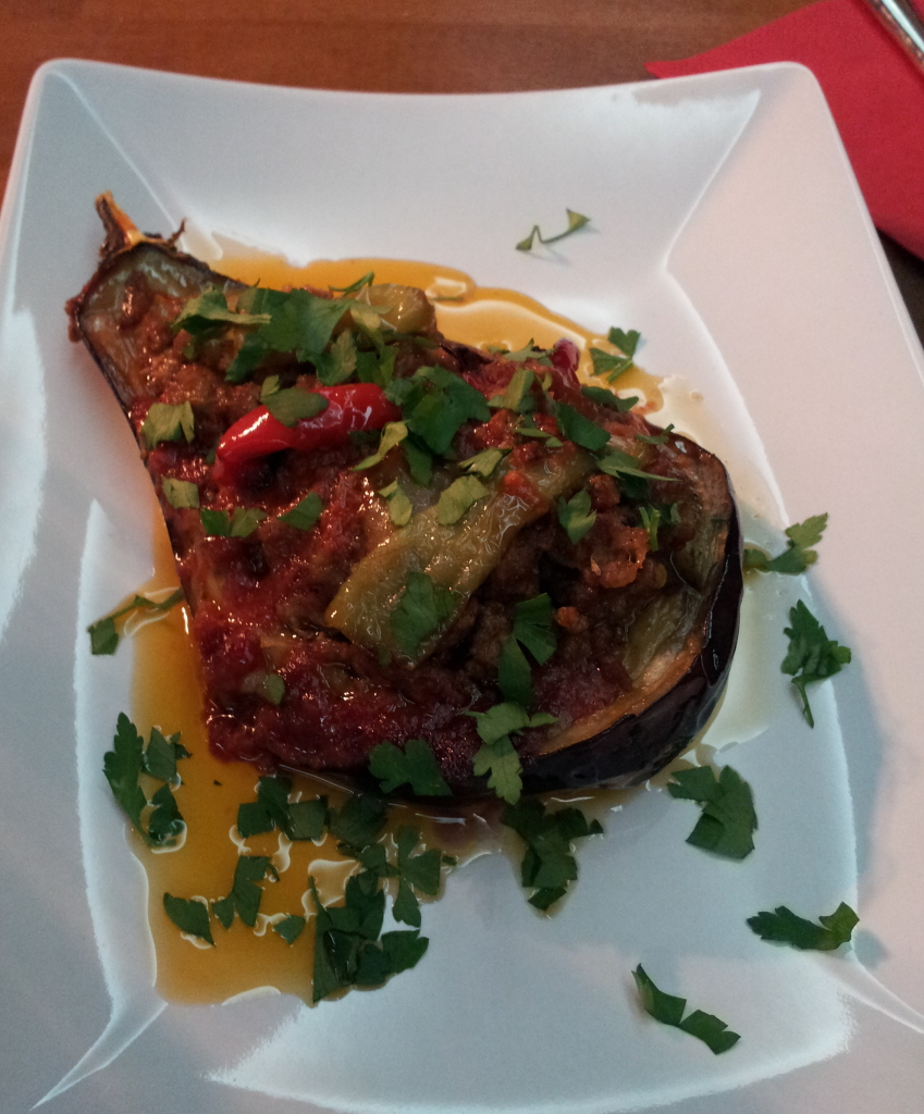 Eggplant stuffed with ground beef and topped with peppers and parsley- a great example of Mediterranean or Turkish food in Berlin