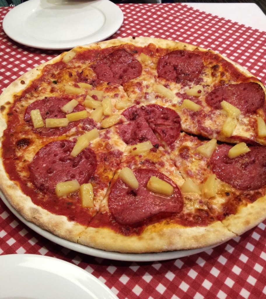 Deer, pineapple, and salami pizza in Helsinki Finland